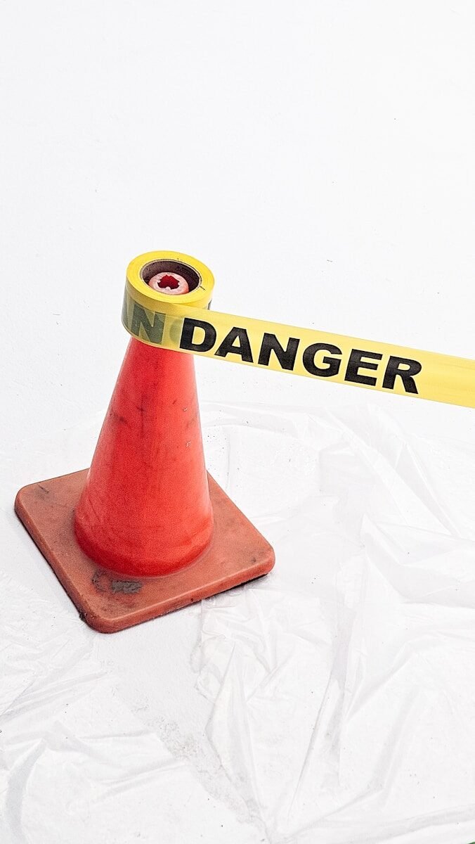 A caution cone with "danger" tape.